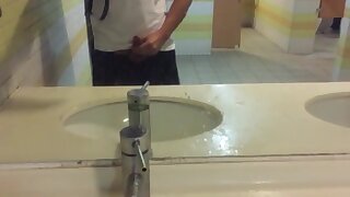 A student received a helping hand from his friend in the bus station bathroom.