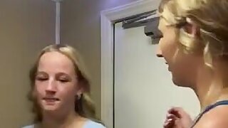 Two blonde girls make out in the bathroom
